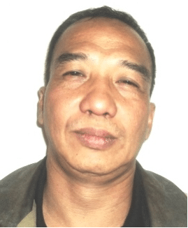 Ernesto Vargas Jnr, a middle-aged man with short dark hair, faces the camera with a neutral expression. He is wearing a dark shirt and jacket against a plain white background.